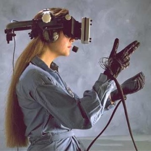 Woman wears virtual reality visual headset and holds hand controls to control what she does during the event.