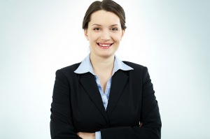 Woman wearing business suit and smiling.