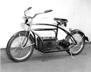 Old picture of a bicycle with a gas tank and motor added to make it like a motorcycle.
