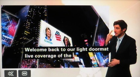 A TV screen shows the news and the captions read, "Welcome back to the light doormat coverage of the..."